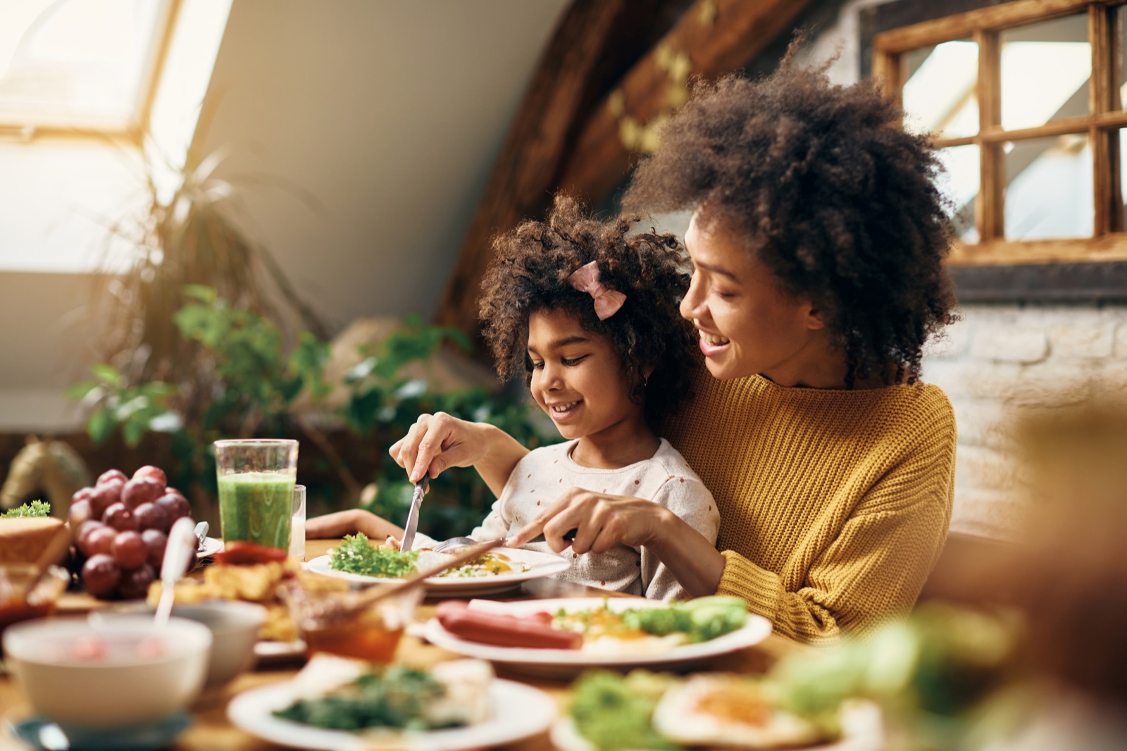 A mother and daughter sharing a meal together at the table